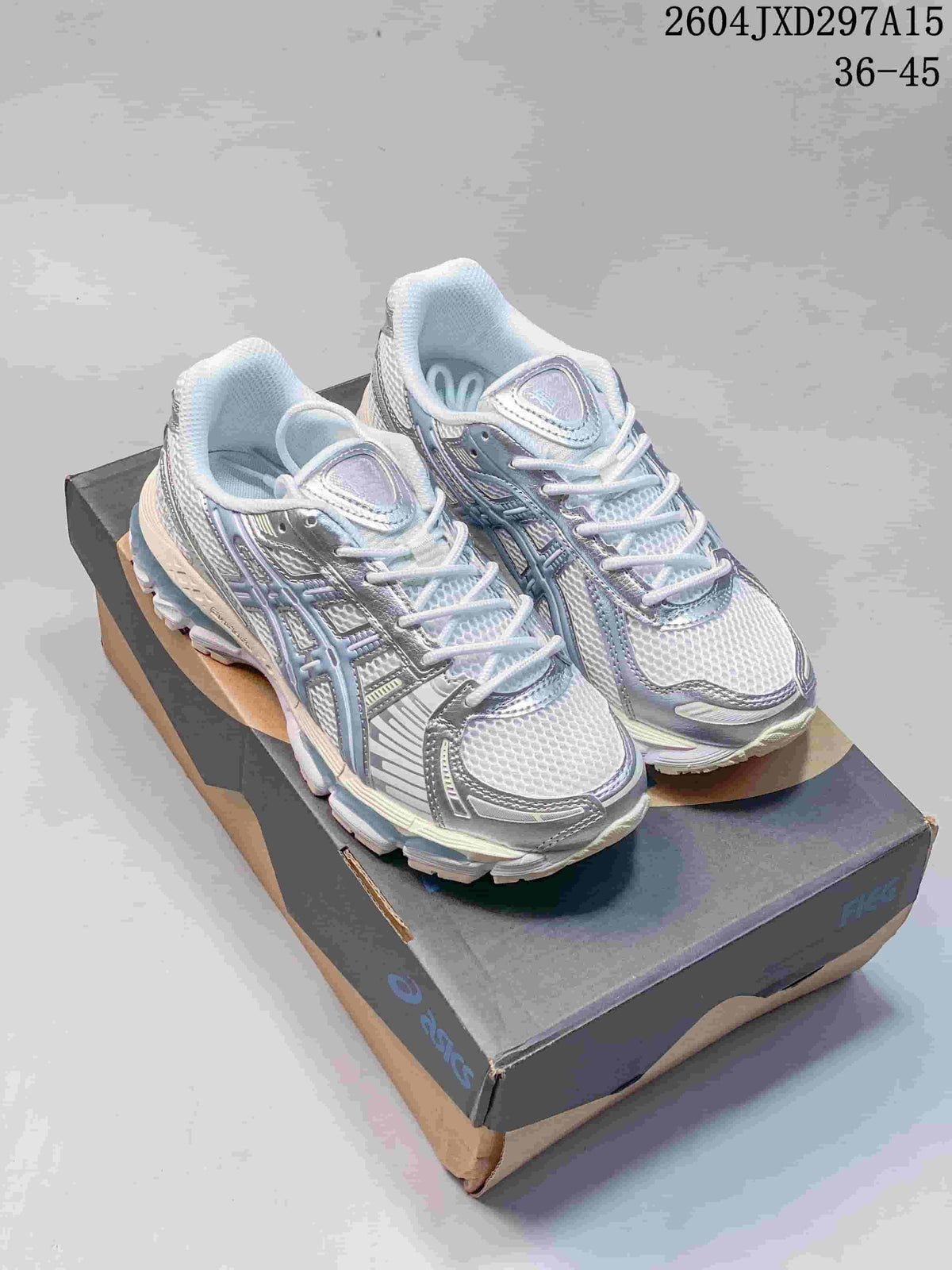 Pair of pale silver and blue ASICS Gel-Kayano 12.1 sneakers on a shoe box