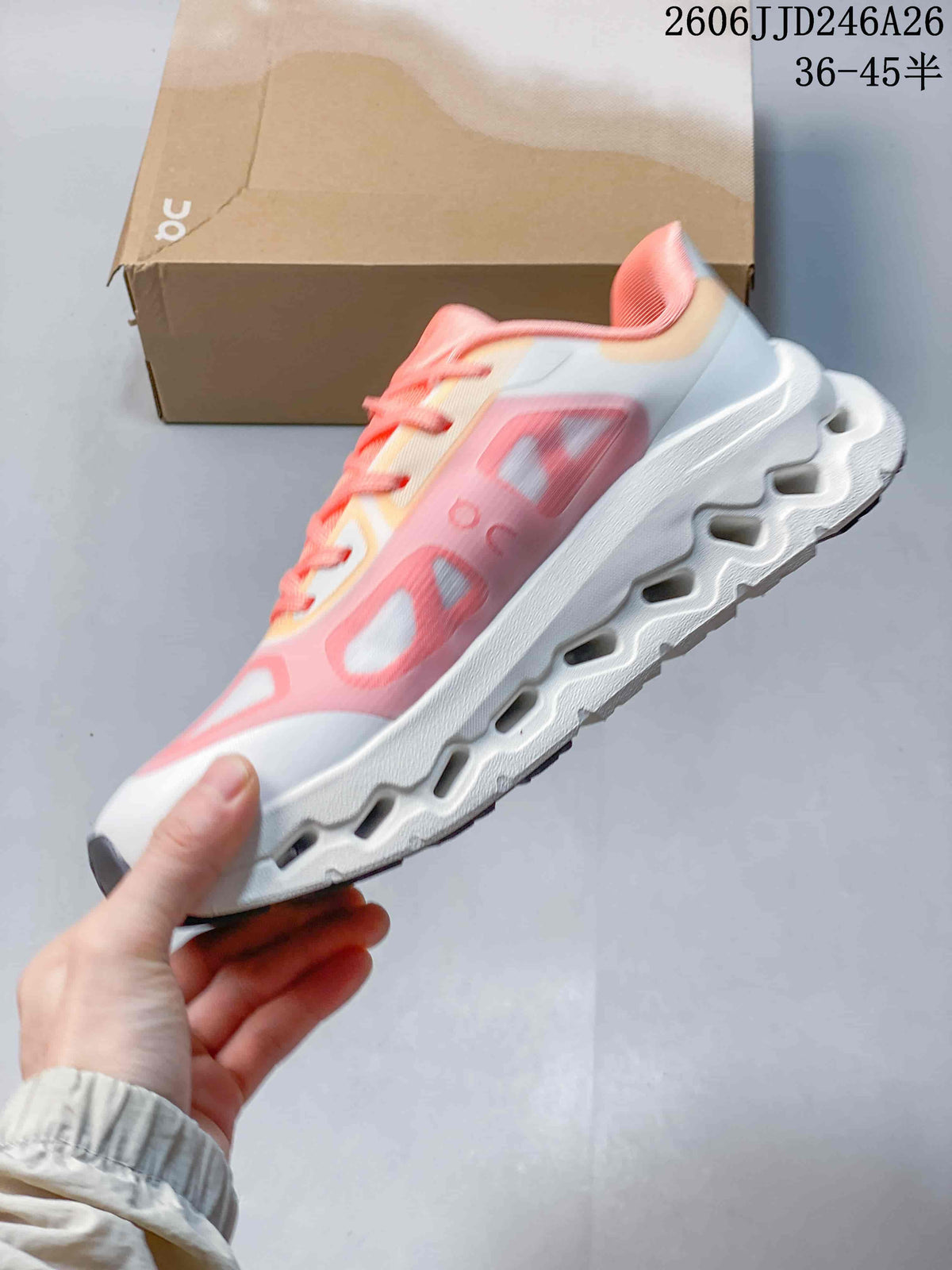 Side profile showing the pink translucent overlays, white upper, and sculpted sole cutouts.