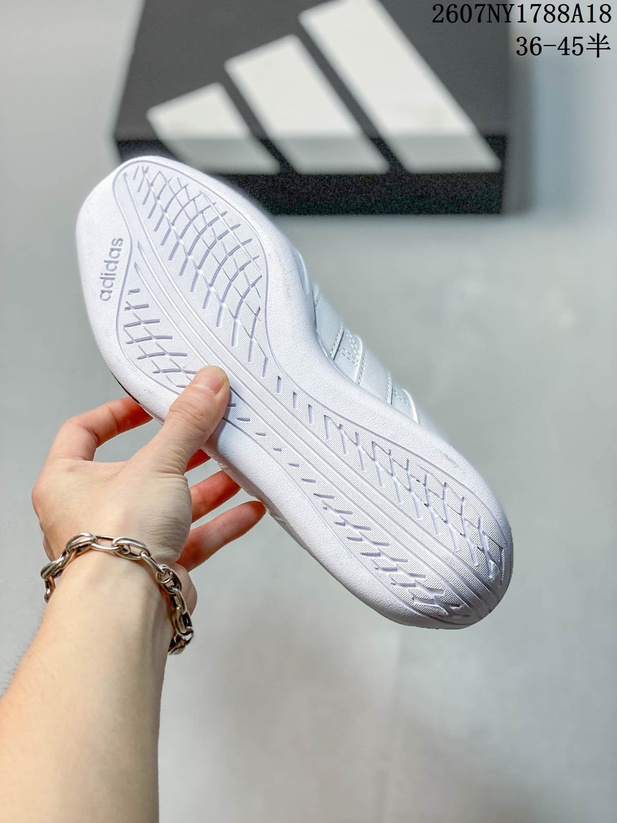 Close view of the white textured outsole with the adidas wordmark.