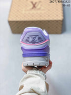 Rear view of the purple and grey sneaker showing the raised LV heel emblem, padded collar, and layered outsole.