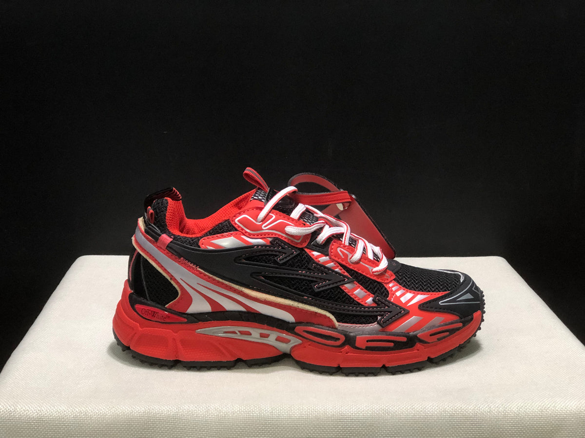Close side profile of one sneaker highlighting the lace-up construction, layered panels, and rugged outsole.