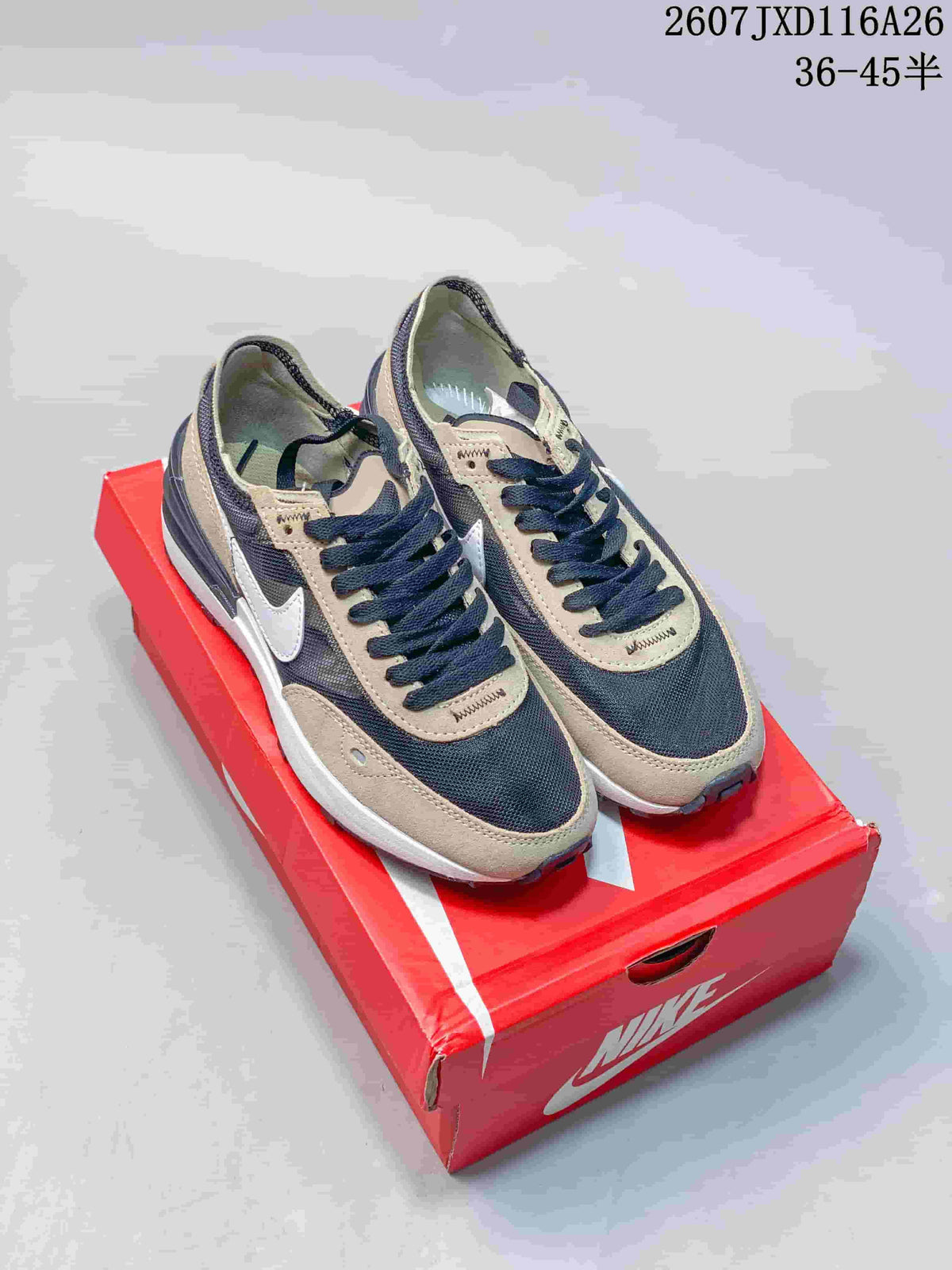 Pair of Nike Waffle One GS sneakers in black and brown displayed on a red Nike shoebox; image text shows product code 2607JXD116A26 and size range 36–45.