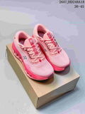 Pair of pink On Cloudtilt sneakers displayed on a shoebox, showing the lace-up front, branded tongues, and sculpted soles.