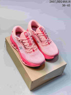 Pair of pink On Cloudtilt sneakers displayed on a shoebox, showing the lace-up front, branded tongues, and sculpted soles.