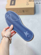 Blue patterned outsole of the sneaker showing a repeating zigzag tread and star-shaped branding.