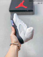 Side view highlighting the white upper, translucent mesh-style panel, black midsole, and pink accent.