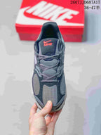 Top view of a gray Nike V5 RNR sneaker showing the mesh-style toe panel, laces, and tongue branding.