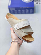 Off-white and taupe clog showing the adjustable strap, tan footbed and light textured outsole.