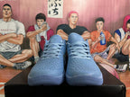 Front view of blue-gray Nike Kobe basketball shoes with textured uppers and laces