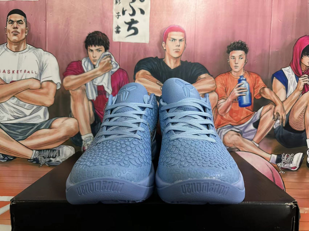 Front view of blue-gray Nike Kobe basketball shoes with textured uppers and laces