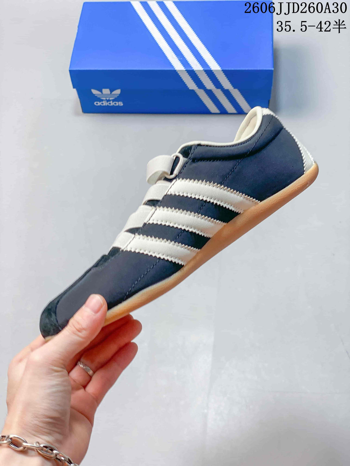 Side profile of the navy Tokyo MJ sneaker with cream stripes and gum-colored sole