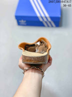 Rear view of a tan closed-toe mule showing the raised heel area, footbed, and textured outsole edge.