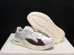 Angled view of one sneaker with the outsole visible, showing its molded tread pattern.