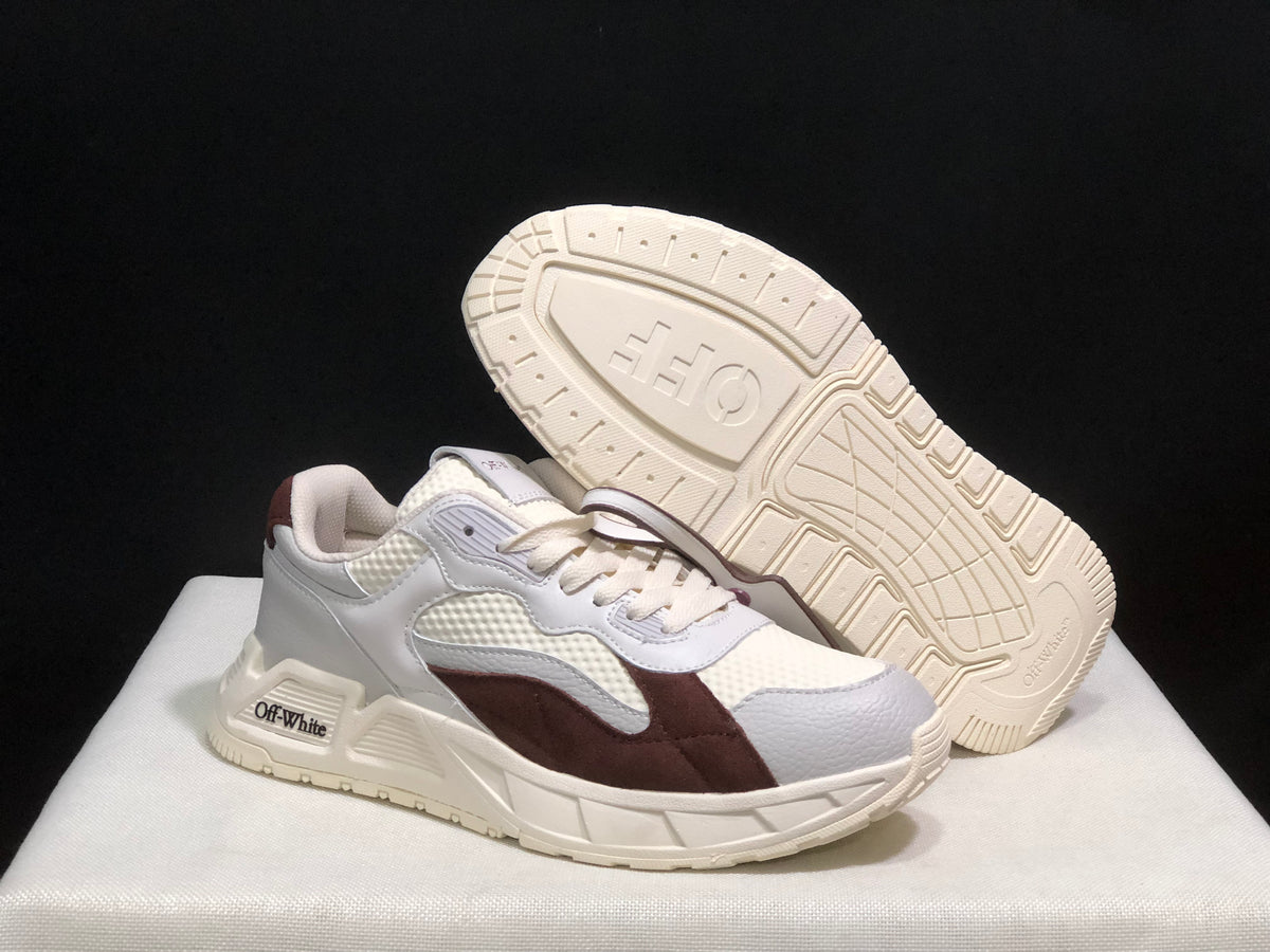 Angled view of one sneaker with the outsole visible, showing its molded tread pattern.