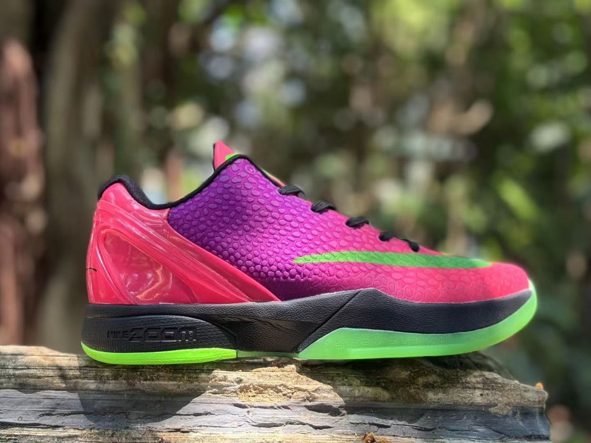 Side view of a pink and purple Nike Kobe 6 shoe with green accents and black midsole
