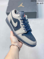 Angled side view of a gray and navy low-top sneaker showing the color-blocked upper, Swoosh, laces, and rubber outsole.