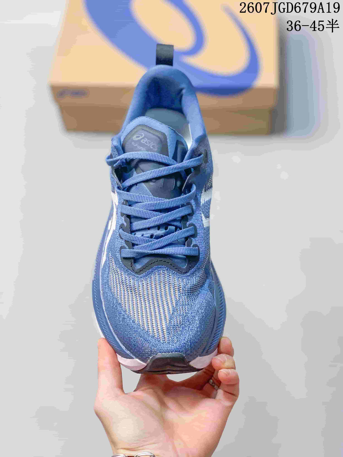 Top view of the blue sneaker showing the lace arrangement, padded tongue, textured toe box, and ASICS branding.