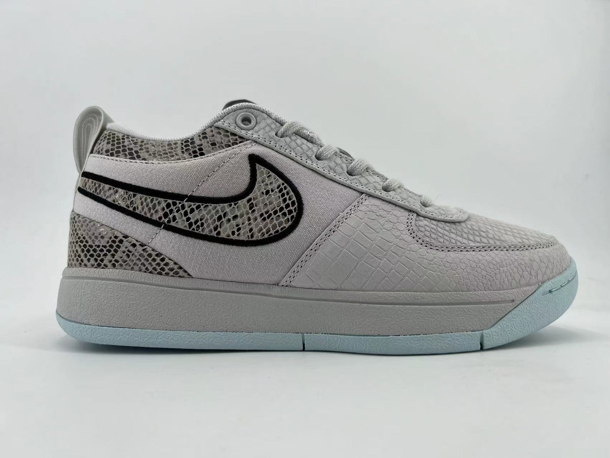 Opposite side profile of the gray sneaker with pale blue outsole