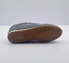 Bottom view showing the brown rubber outsole with a geometric traction pattern and Alo mark.
