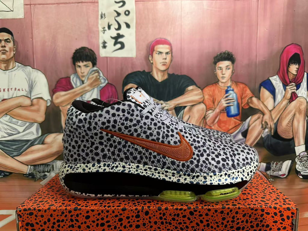 Side view showing spotted upper, brown-toned Swoosh, and visible Air Zoom sole unit