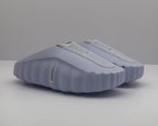 Pair of purple Nike slides shown from a front three-quarter angle.