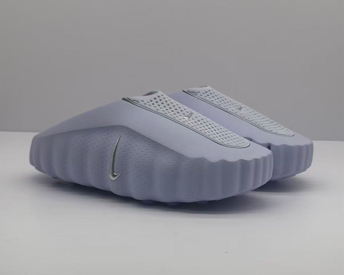 Pair of purple Nike slides shown from a front three-quarter angle.
