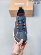 Top view showing the lace-up construction, dark gray upper, orange lace details, and protective toe area.