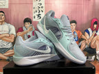 Pair of light blue Nike basketball shoes shown from the side