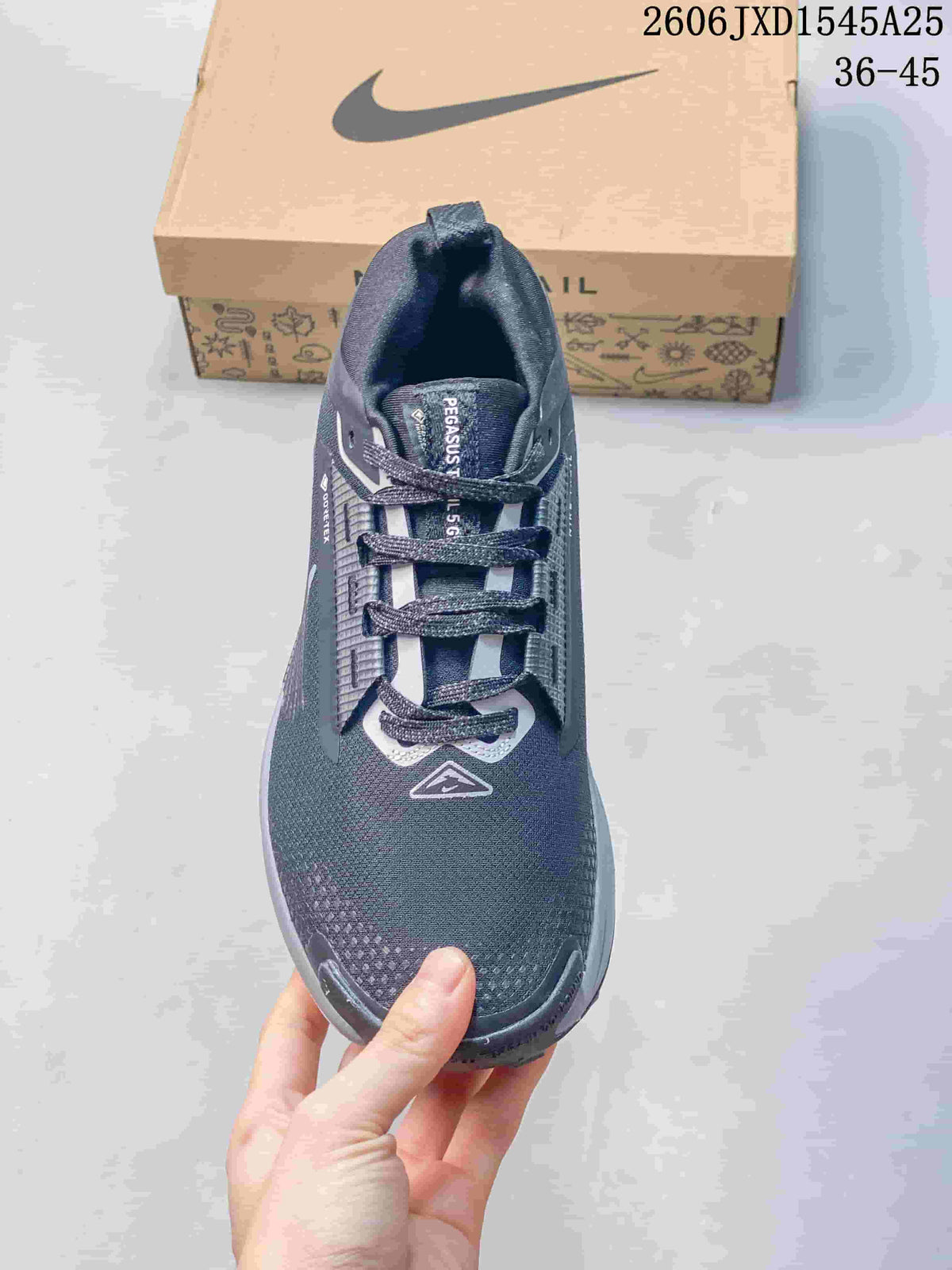 Top view of a dark gray Nike Pegasus Trail shoe with laces