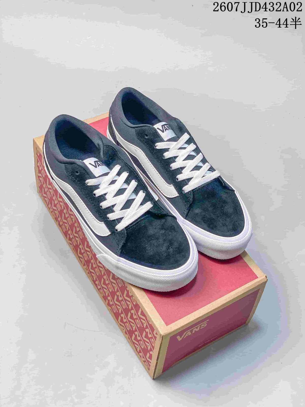 Pair of navy Vans Vero LS low-top sneakers with white laces and side stripes, shown on a Vans box
