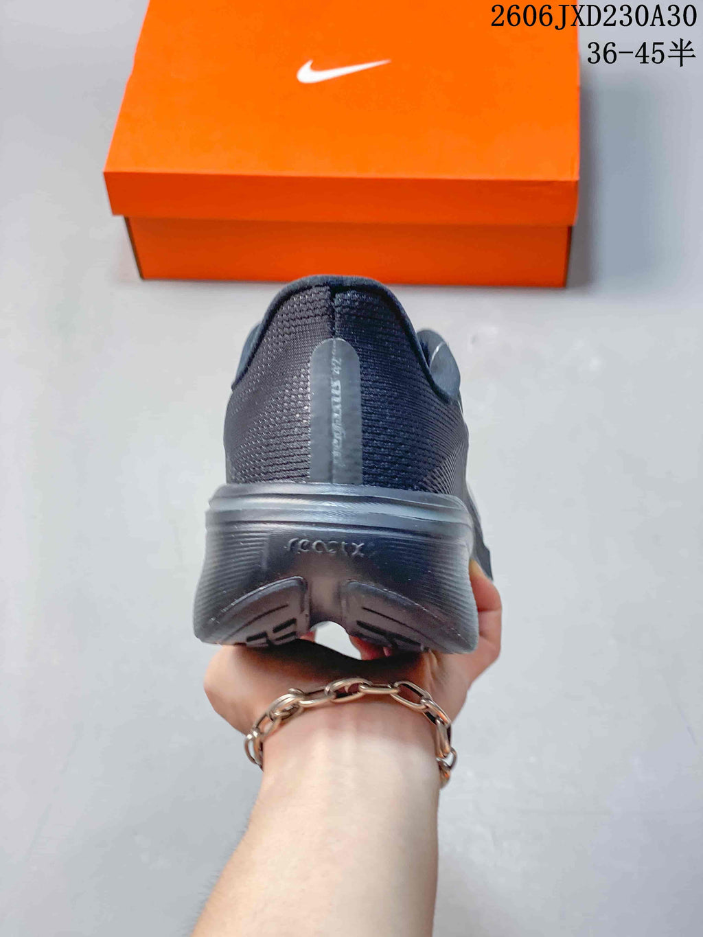 Rear view showing the heel and outsole of a dark gray running shoe.
