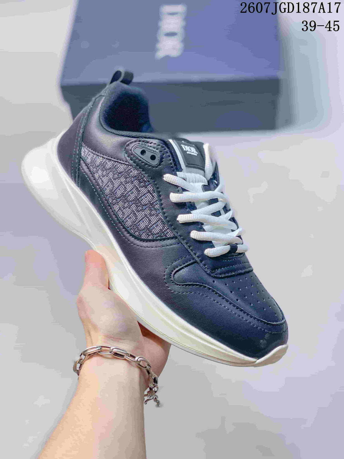 Dark navy Dior B25 Runner sneaker with a patterned side panel, white laces, and light outsole.
