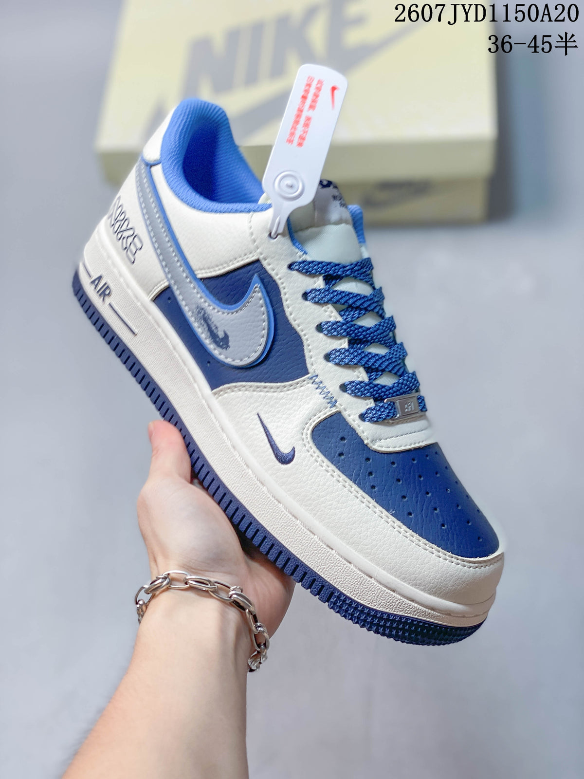 Angled side view showing the blue and white upper, swoosh detail, lace area, and outsole.