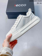 Side view of the white sneaker with perforated panels and a thick sole