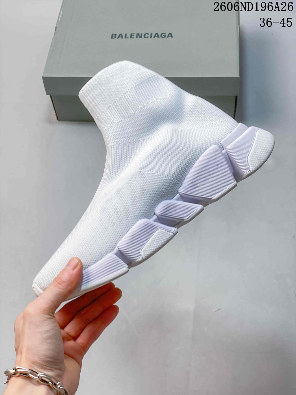 Side profile of a white sock sneaker showing the knit upper and segmented white outsole.