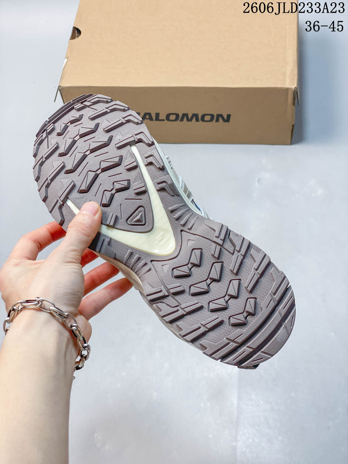 Outsole view of blue and light neutral Salomon XA Pro 3D Suede trail running shoe
