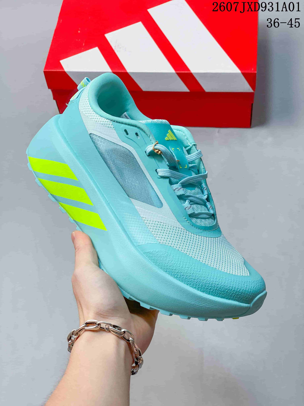 Angled side view of the aqua adidas Hyperboost ATR sneaker with lime stripes.