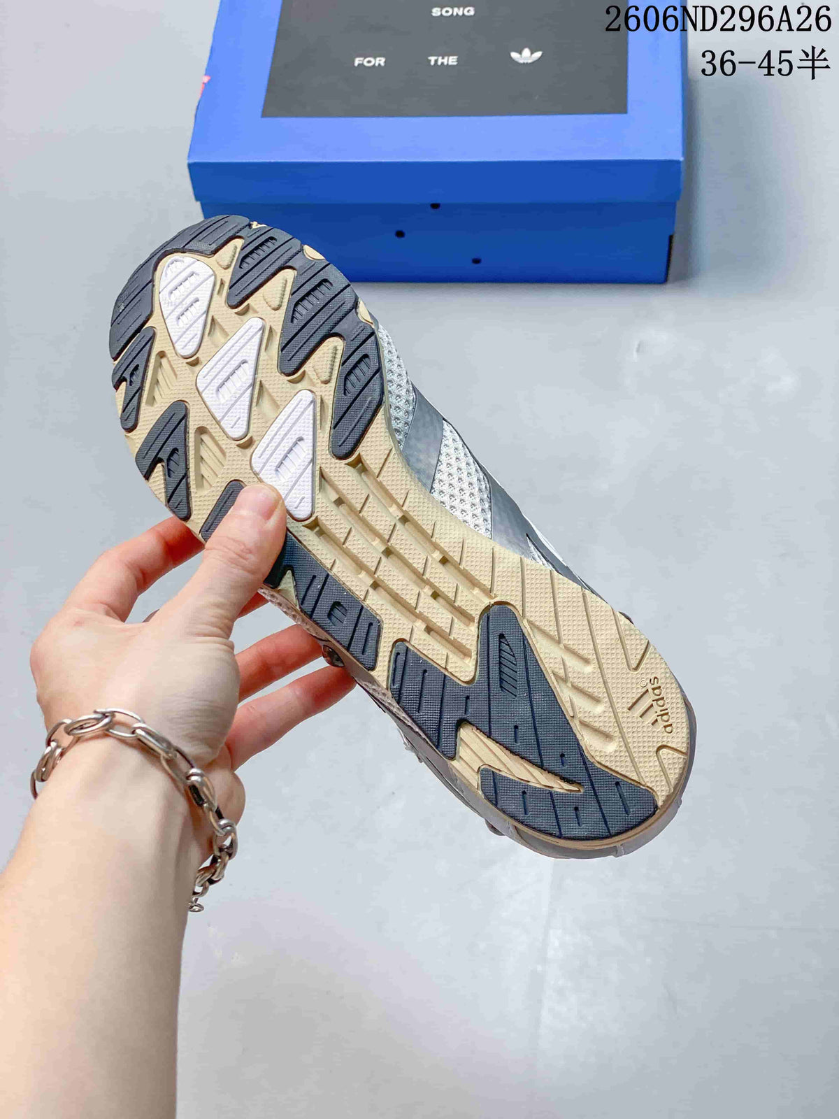 Underside view showing the sneakers' contrasting gum-toned and dark patterned rubber outsole.