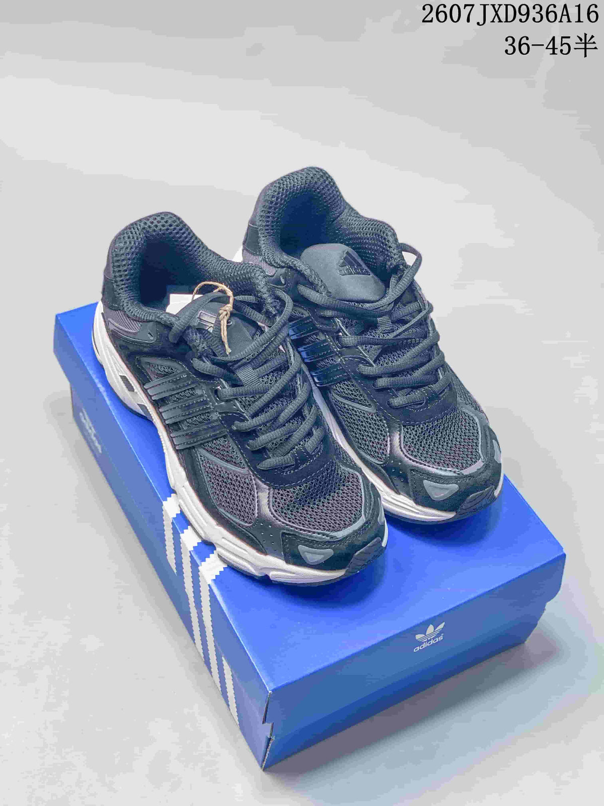 Pair of dark adidas Response CL style sneakers displayed on a blue adidas shoebox.