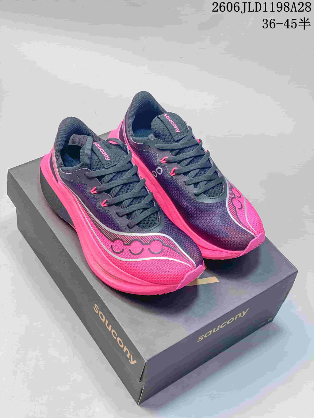 Pair of navy and bright pink Saucony Endorphin Speed running shoes on a branded shoe box