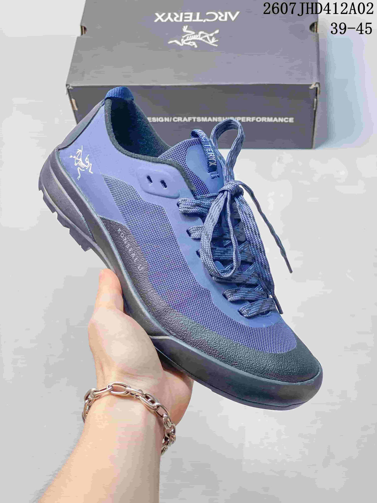 Angled side view of the blue shoe with its lace-up closure and treaded sole