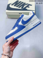 Side profile of the white and blue low-top sneaker with contrast stitching and a blue outsole.