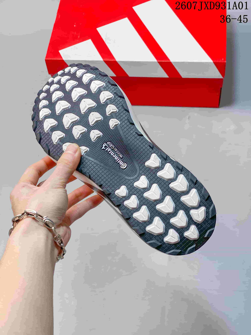 Close-up of the sneaker outsole with raised tread elements.