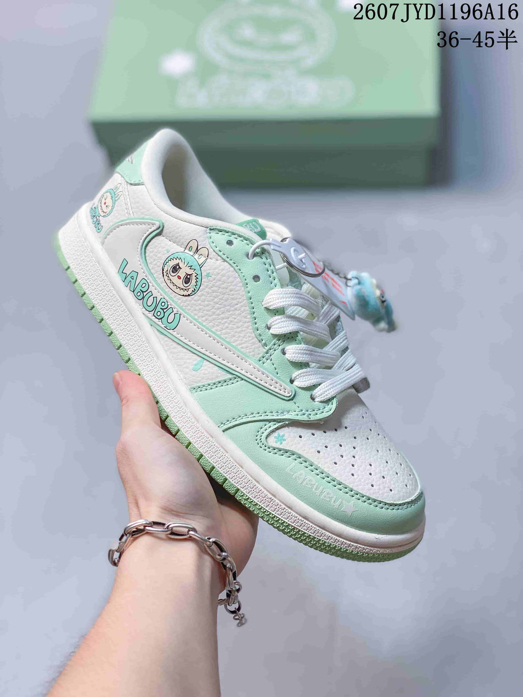 Mint green and white low-top Jordan sneaker with Labubu graphics, white laces and a mint outsole.