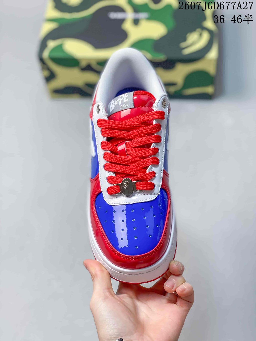 Top view showing the blue perforated toe box, red laces, white eyestay, and BAPE STA tongue label.
