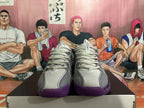 Front view of Nike basketball shoes showing perforated toe panels, gray laces, and purple toe accents.