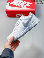 Side profile of a white low-top sneaker with a grey Swoosh