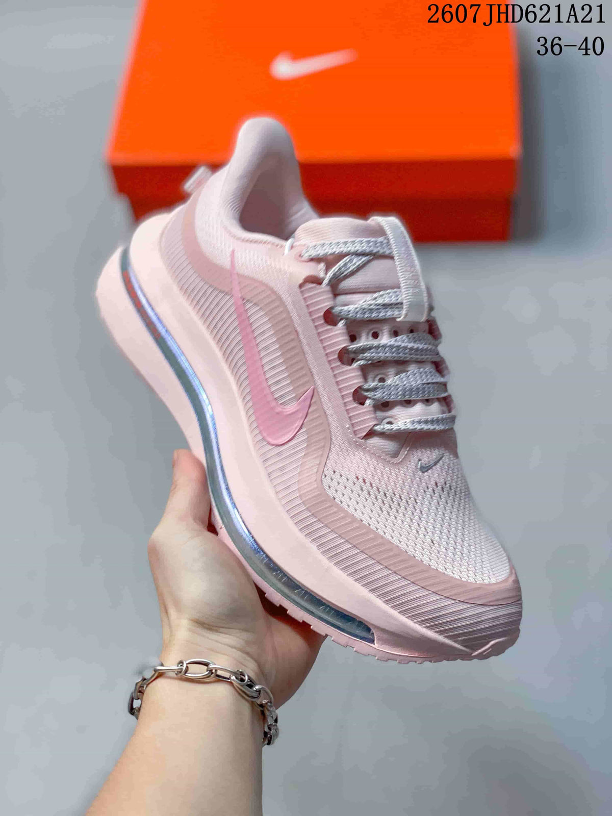 Angled side view of the pink Nike sneaker with layered panels and visible midsole air unit.