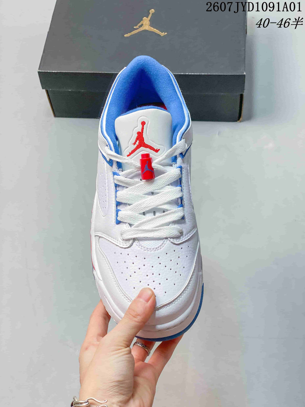 Top view showing perforated toe panels, white laces, and red tongue branding