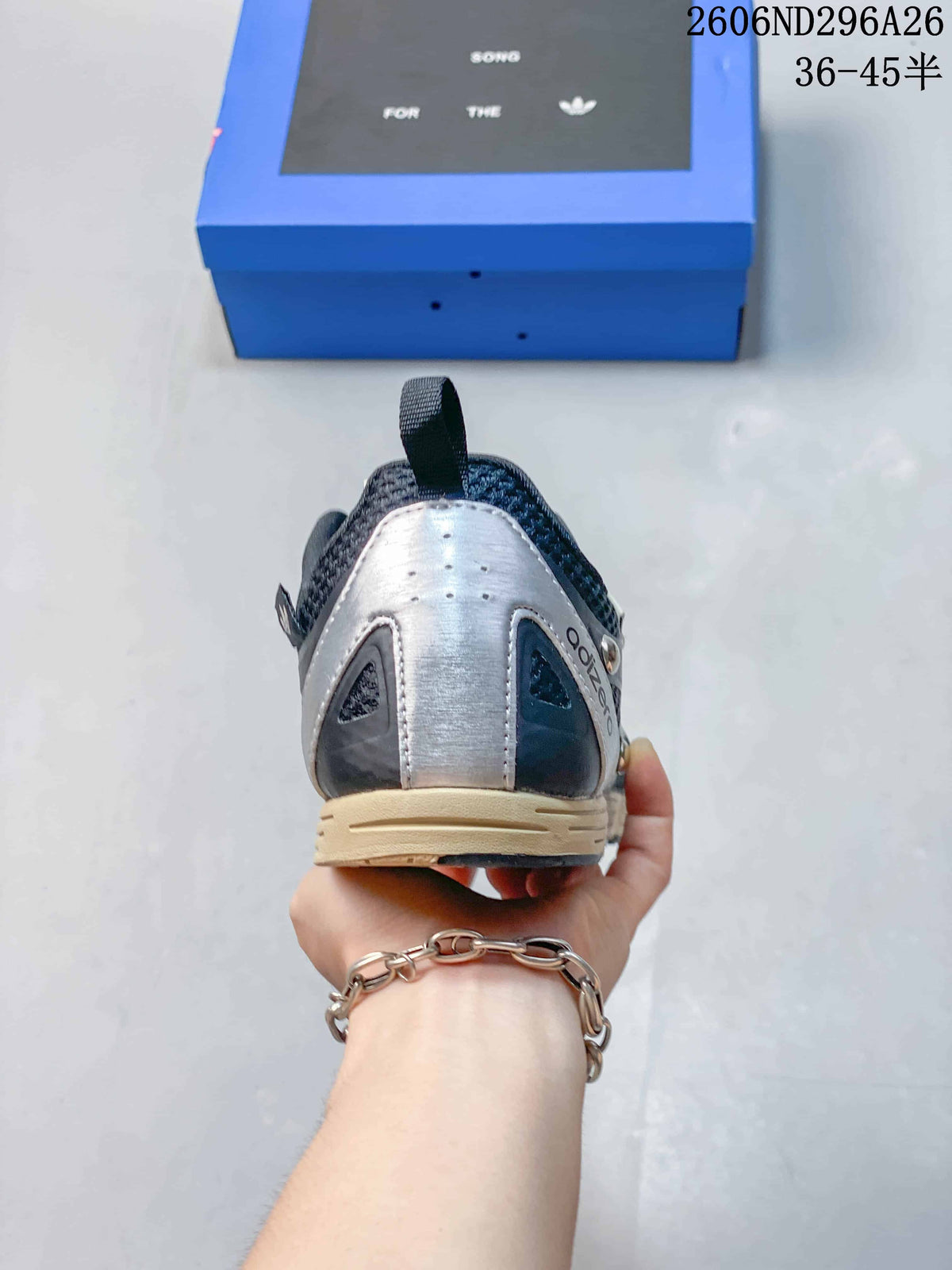 Rear view showing the silver-toned heel panel, dark collar, and contrasting cream midsole.
